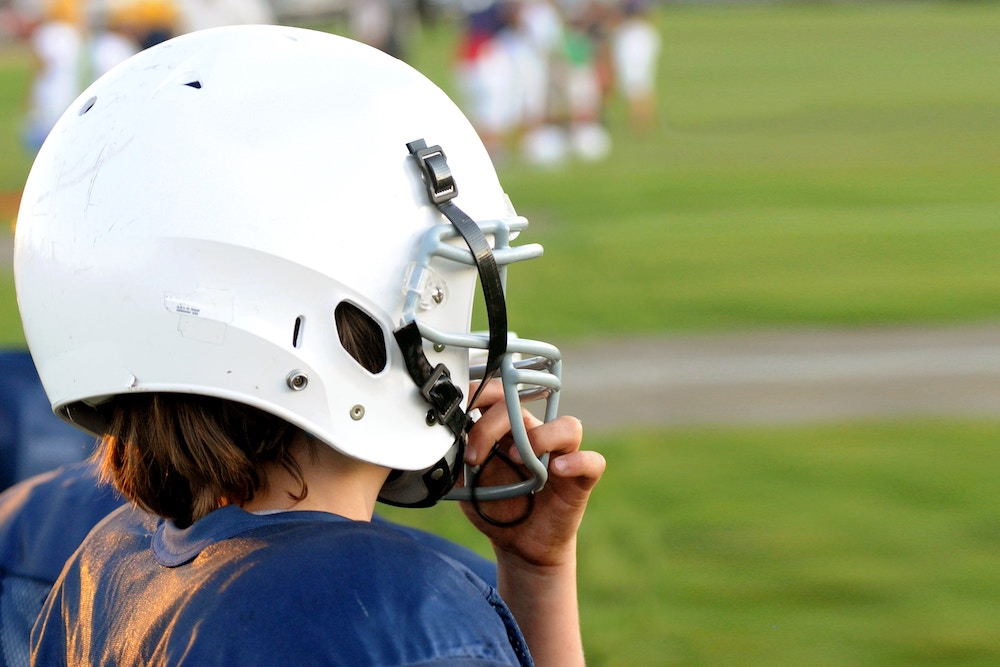 Child wearing a football helmet